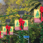 MainStreet-Designs-Homepage-Slider-Image4 double banner with red Christmas bow hanging on street lights