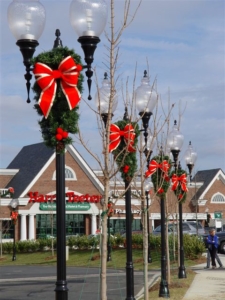 holiday wreaths with bows on vintage inspired street lamp posts