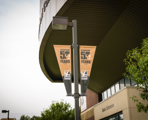 Streetscape Banners - Mainstreet Designs Anoka Technical College pole banner - Anniversary Year