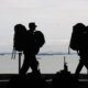 silhouette of military walking along the beach