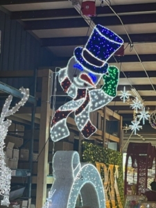 Carpenter Decorating Hat Tipping Snowman pole mount decoration available at MainStreet Designs Inc. City Christmas Decor