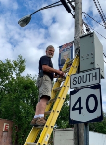 hanging a hometown hero banner on a city street